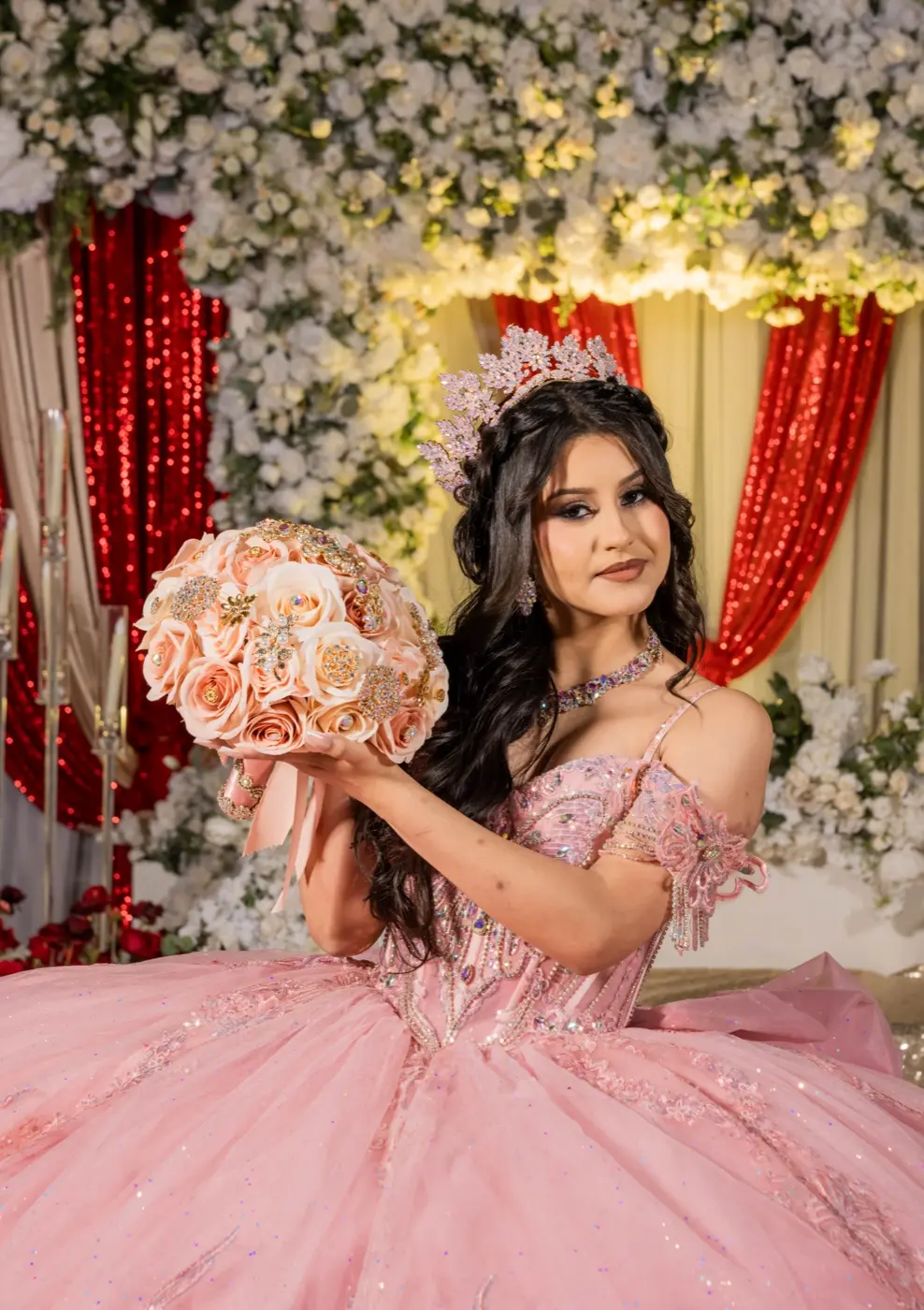 Quinceañera in a pink gown holding a bouquet