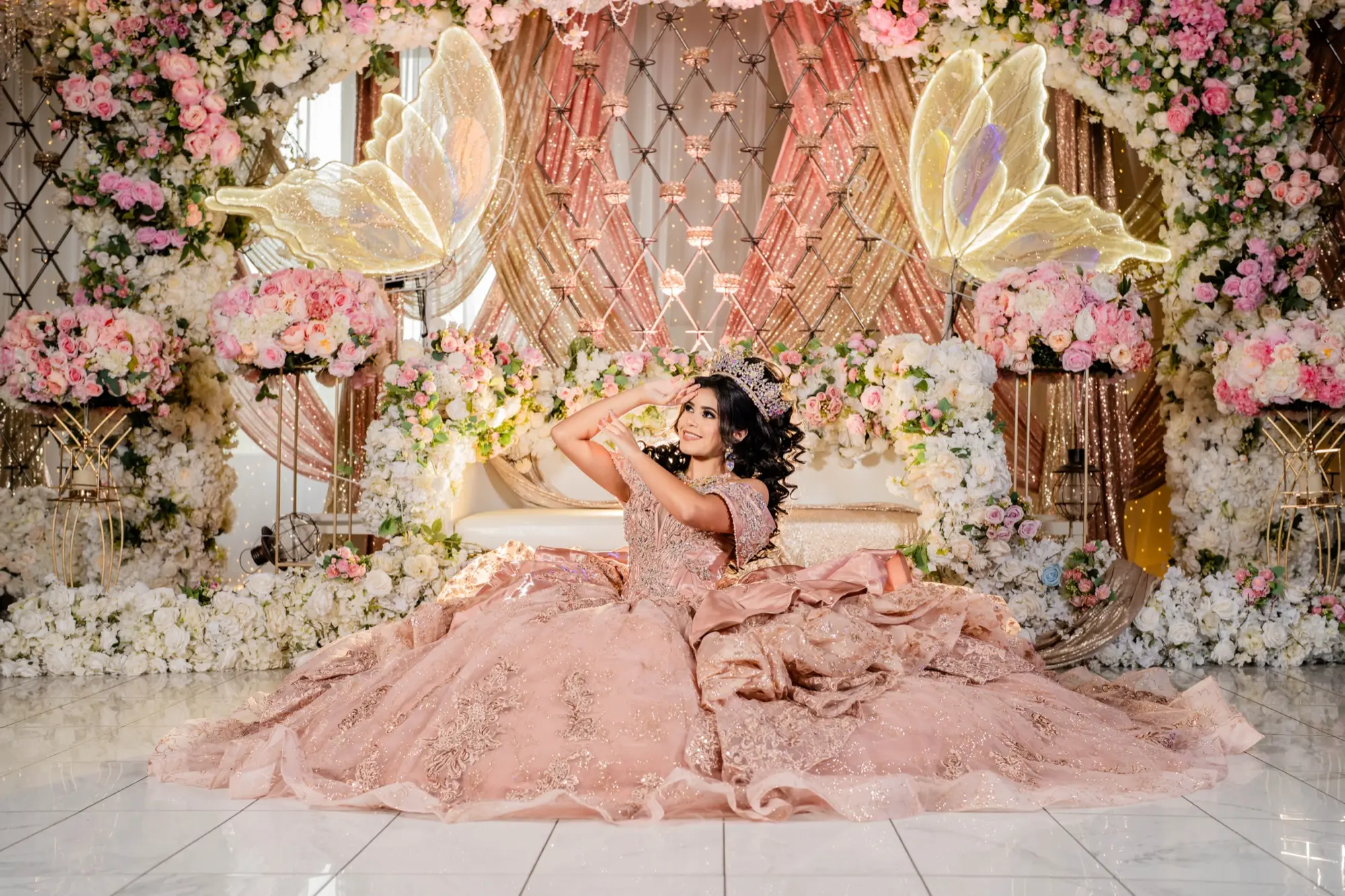 Quinceañera in a rose gown with butterfly decor