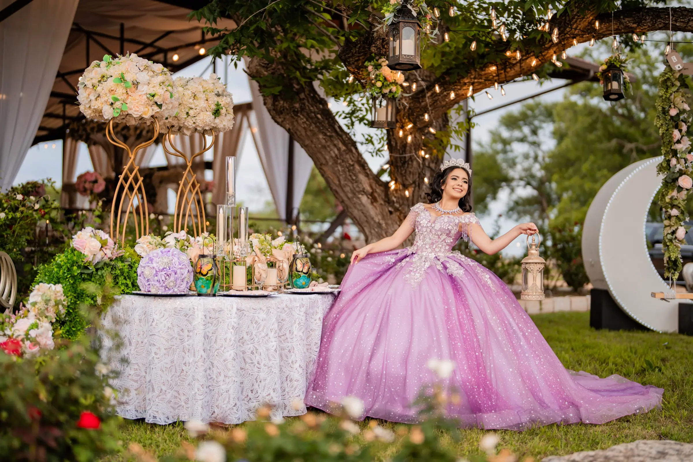 Quinceañera in a lilac ball gown in a garden