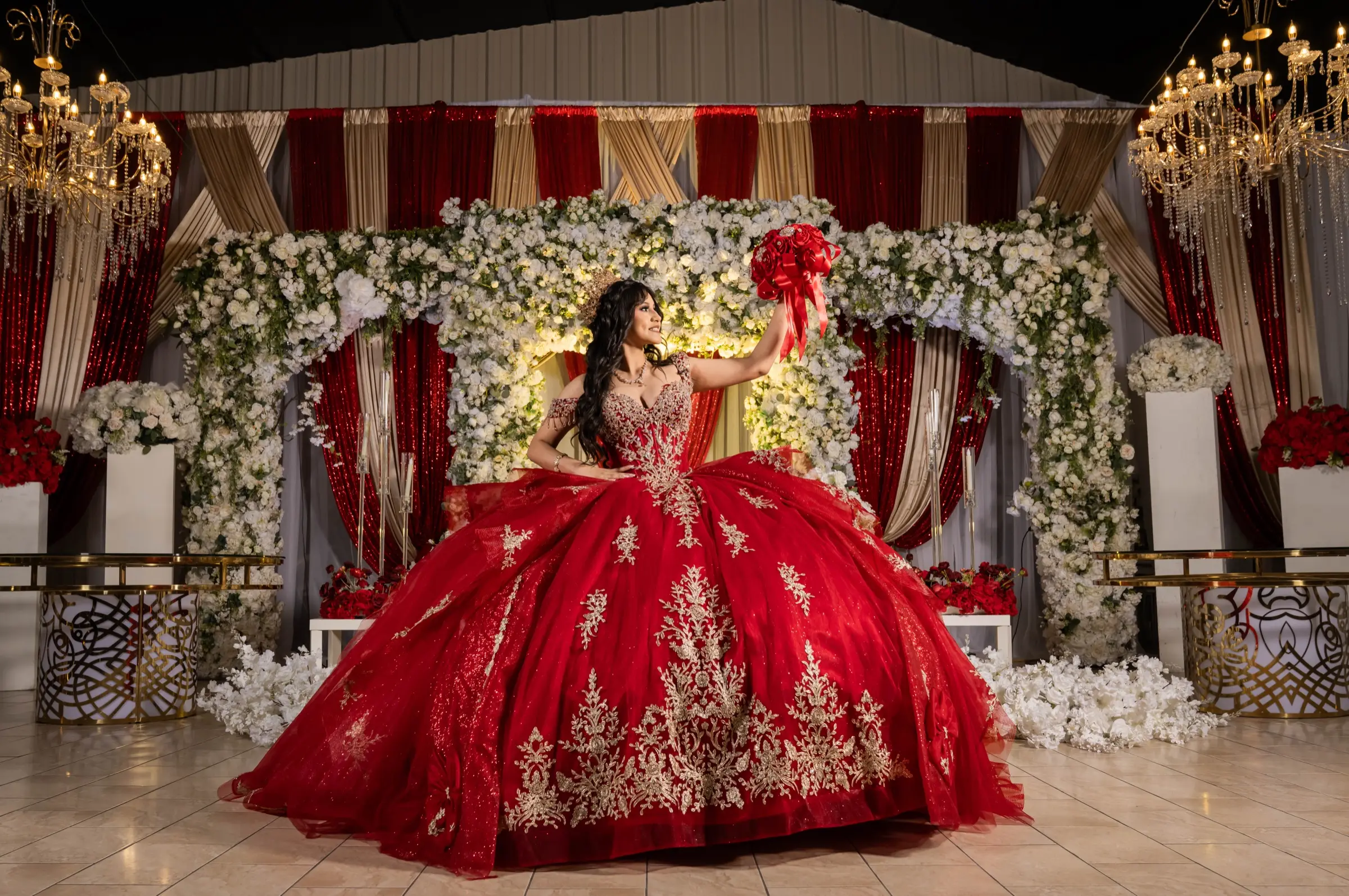 Quinceañera in a red ball gown with gold embroidery